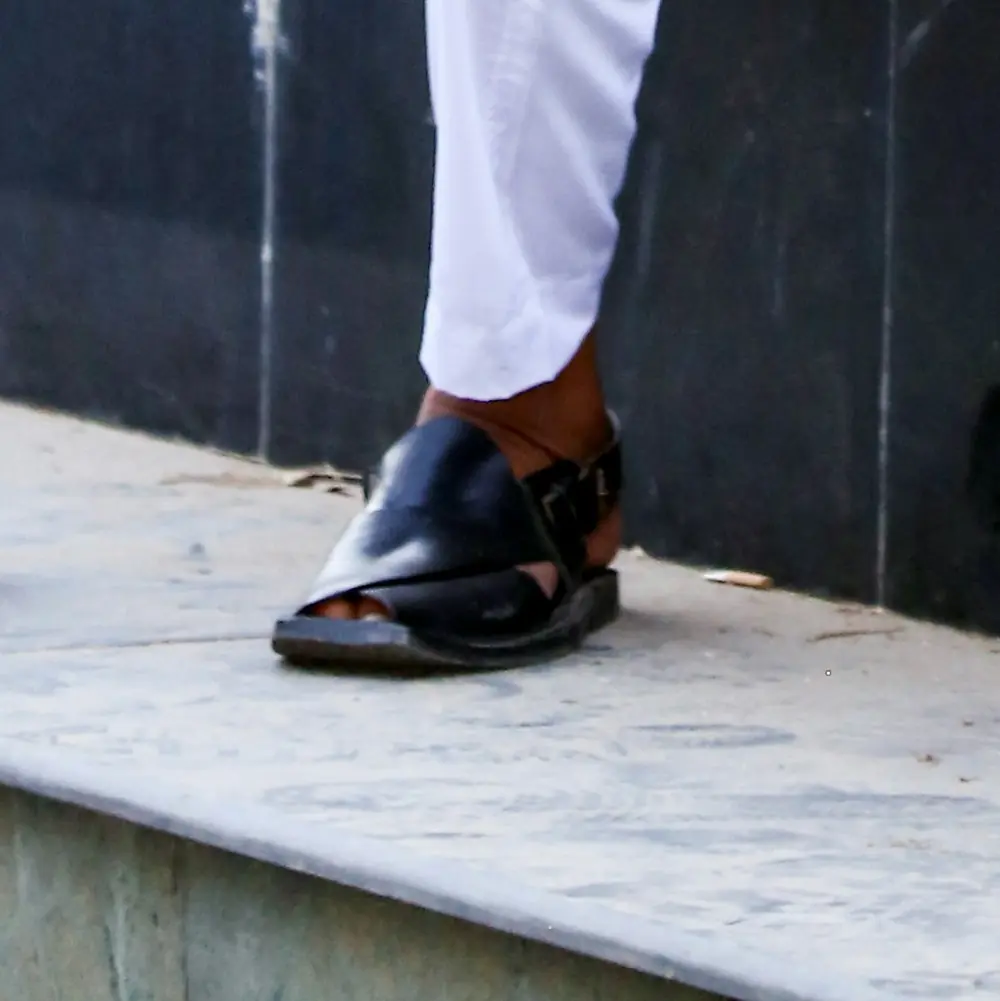 Black Peshawari chappal with a white shalwar