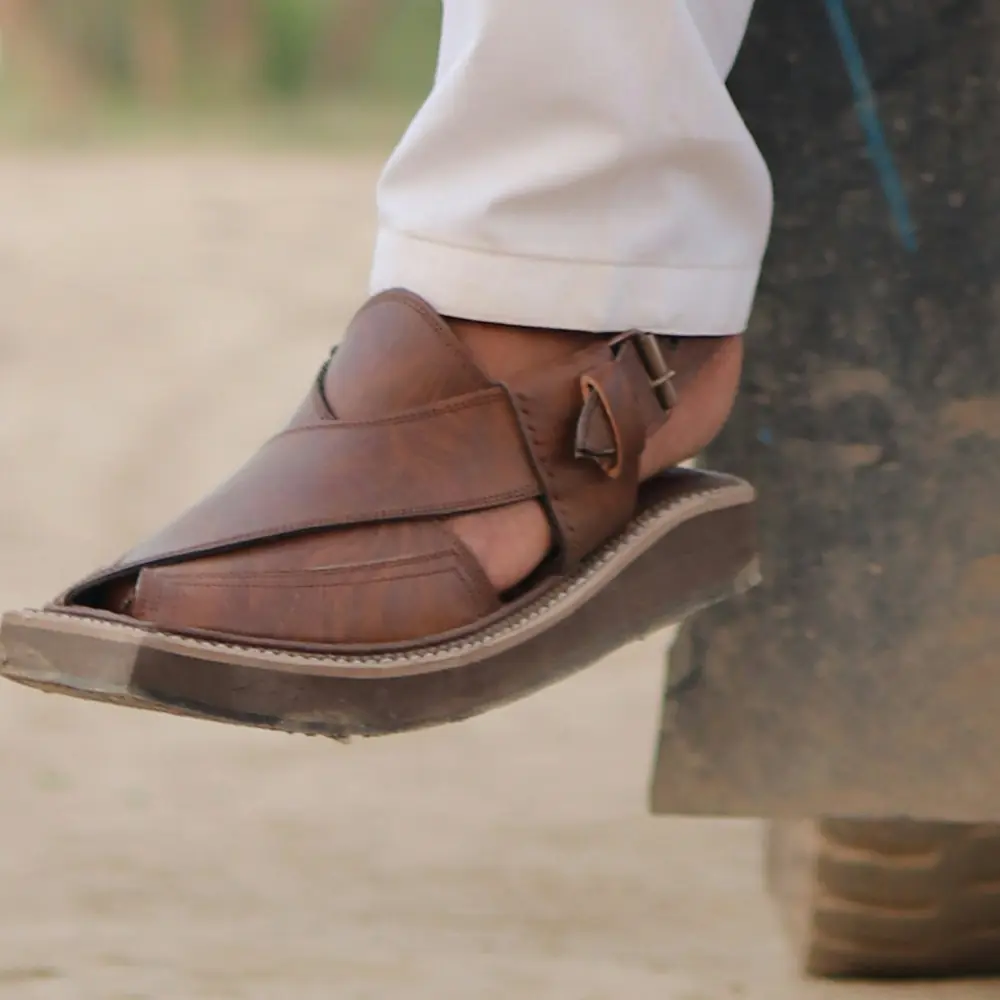Brown Peshawari chappal on the foot