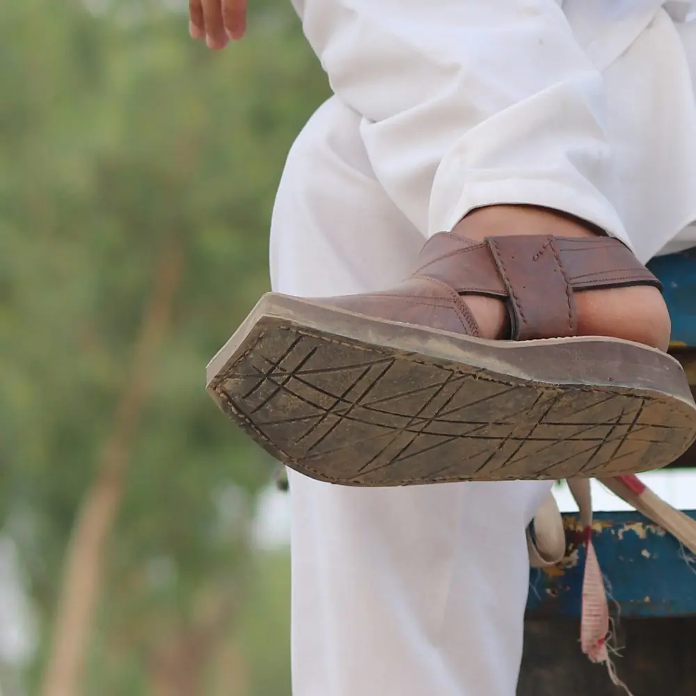 The tyre sole of a brown Peshawari chappal