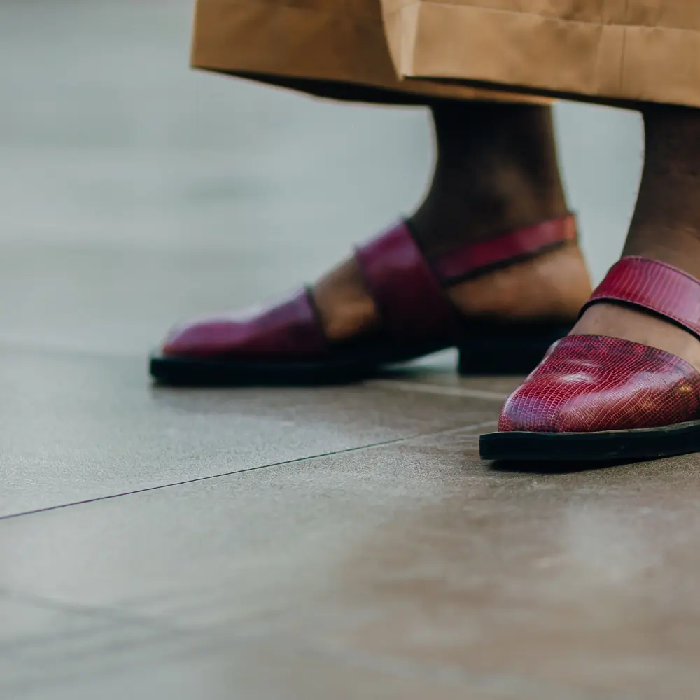 Standing in maroon Peshawari chappals