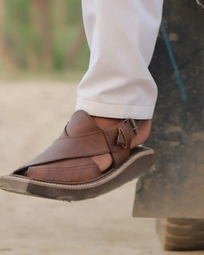 Brown Peshawari chappal on the foot